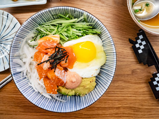 served bowl with bibimbap with salmon sashimi
