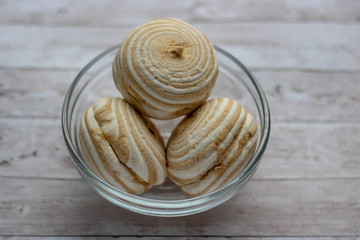 Vanilla marshmallow zephyr with caramel on a wooden table. Selective focus. Copy space