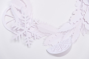 Christmas wreath made of white paper on white background