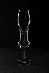 An empty glass of wine and liquor on a dark background.