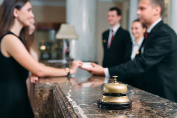 Fototapeta na wymiar Picture of guests getting key card in hotel.