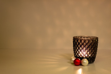 candle light in a Black glass with ornaments