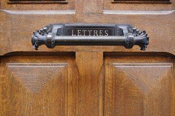 Wooden door with handle and sign Letters