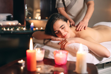 Spa, massage. Young dark-haired beautiful girl doing massage.