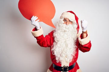 Middle age man wearing Santa costume holding speech bubble over isolated white background annoyed and frustrated shouting with anger, crazy and yelling with raised hand, anger concept