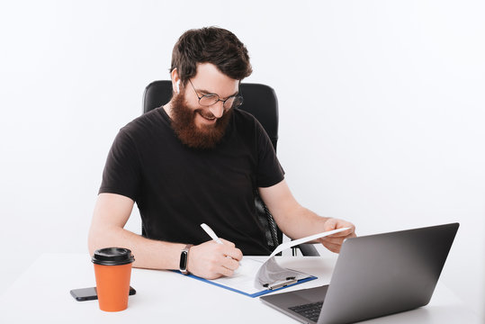 Photo of happy freelancer, satisfied after checking his statistics, isolated background