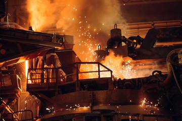 Melting of metal in a steel plant. High temperature in the melting furnace. - obrazy, fototapety, plakaty