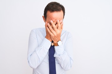 Middle age businessman wearing elegant tie standing over isolated white background with sad expression covering face with hands while crying. Depression concept.