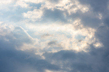 landscape sky with blue clouds and sunbeams at sunset. Background texture
