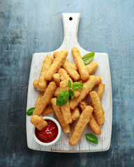 Crispy Halloumi cheese sticks Fries with sweet hot sauce on white wooden board