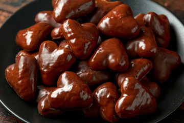 Christmas Gingerbread, lebkuchen heart with decoration, gifts, green tree branch on wooden rustic table
