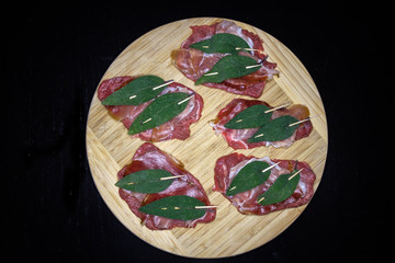 Saltimbocca with beef, parma ham and sage leaves, uncooked.