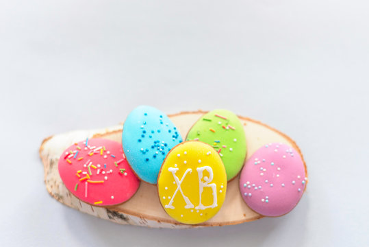 Russian Orthodox Easter. Letters symbol "Christ Has Risen". Colorful Easter sweets and background. 