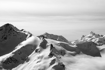 Black and white snowy sunlit mountains