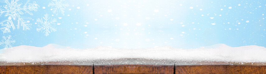 Christmas winter snow background panorama banner long - Snowy wooden rustic table with snowflakes...