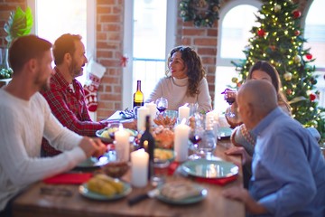 Beautiful family smiling happy and confident. Eating roasted turkey celebrating Christmas at home