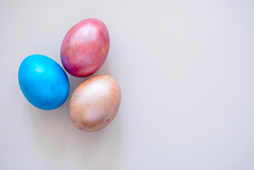 Colored Easter eggs on colorful background. Traditional Christian eastertime.