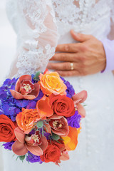 wedding bouquet with hands in background