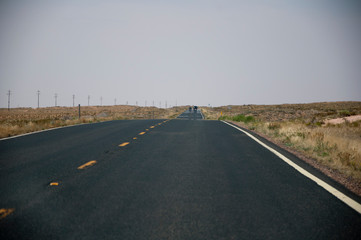 Highway with telegraph poles on the left in USA