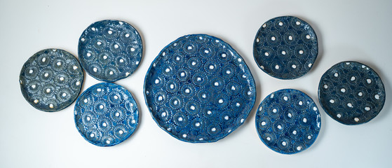 Handmade, crafted ceramic plate set with blue and white bump pattern