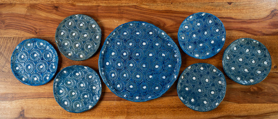 Obraz premium Handmade, crafted ceramic plate set with blue and white bump pattern
