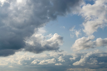 Fototapeta na wymiar White fluffy cumulus clouds on a blue sky