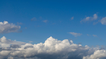 Blue sky background with clouds at the bottom of the sky (Space for text).