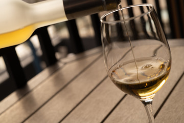 Pouring a glass of wine on a table