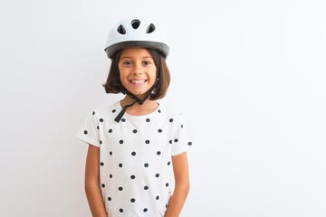 Beautiful child girl wearing security bike helmet standing over isolated white background with a happy and cool smile on face. Lucky person.