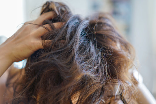 Head of unkempt woman. Itchy scalp or hair loss due to stress.