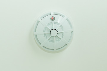 Close up smoke detector on a ceiling.