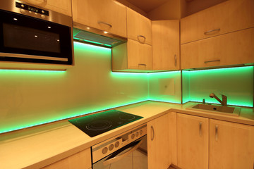 Modern luxury kitchen with custom made furnishings and LED RGB backlit glass
