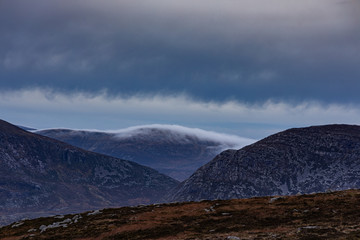 Low clouds forming over a ridge line in the Mourne mountains, County Down, Northern Ireland