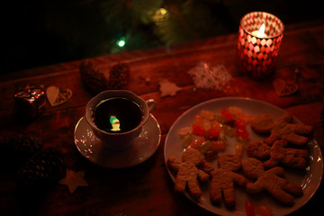 Christmas lights, tea, cookies and candles in candlesticks