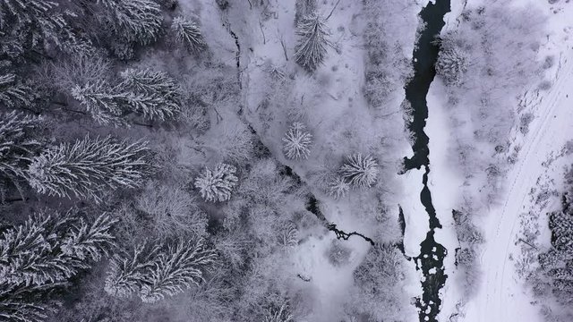 Aerial Drone flight over winter brook at Carpathian Mountains, 4k
