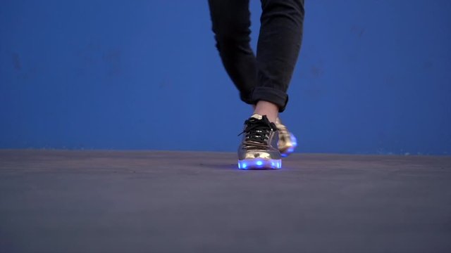 The feet of the teenager who dances with shoes  lights.