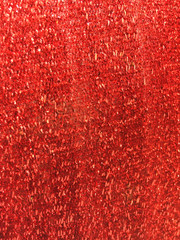 Detail of a red glittering fabric