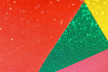 Christmas abstract background with bokeh, colorful background with defocused glitter effect. Yellow, green, red and pink colors.