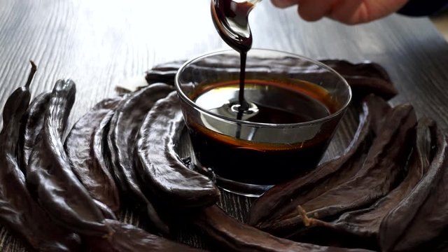 carob molasses and dry carobs together, along with carob syrup and dry carobs, carob syrup for human health,