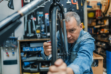 Mature man changing bicycle tire