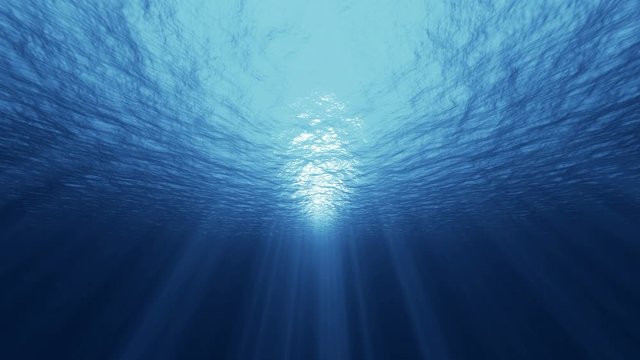 Underwater ocean waves deep blue ripple and flow with light rays. 4K seamless loop