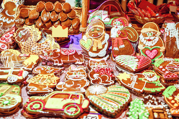 Fototapeta na wymiar Bright icing on top of the gingerbreads of various sizes photographed at the Christmas market in winter Riga in Latvia.