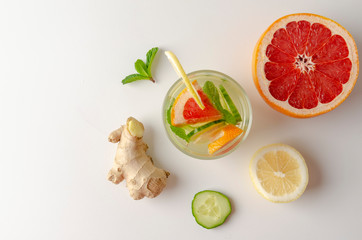 Bottles of fresh detox water on white background