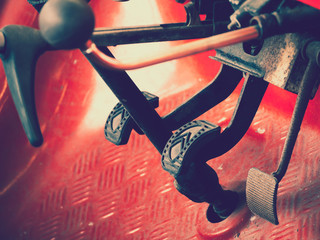 Closeup Brake and accelerator pedal of manual transmission classic car with vintage style in garage.
