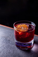 red alcohol coctail on the table with raspberry