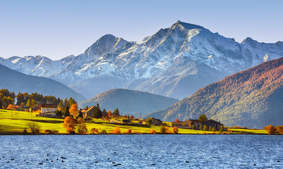 Splendid autumn panorama of Haidersee (Lago della Muta) lake with Ortler peak on backgroun