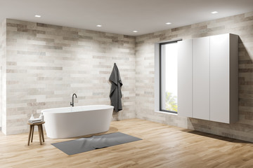 Fototapeta premium Light tile bathroom with tub and wardrobe