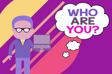 Handwriting text writing Who Are You Question. Conceptual photo asking about someone identity or demonstratingal information Standing man in suit wearing eyeglasses holding open laptop photo Art