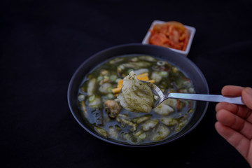 Korean Rice cake Seaweed Fulvescens Soup with oyster which is called Maesaeng-i Tteoggug and kimchi