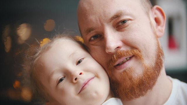 Caucasian family - a dad and daughter - a bald man with ginger beard